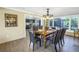 Open dining area with hardwood floors and connection to kitchen, with a view to the outside pool area at 610 Cordova Ne Blvd, St Petersburg, FL 33704