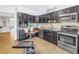 Well-lit kitchen with modern appliances and a mosaic backsplash, adjacent to the breakfast bar at 610 Cordova Ne Blvd, St Petersburg, FL 33704