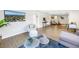 Spacious living room with a tv, and views into the connected dining and living spaces at 610 Cordova Ne Blvd, St Petersburg, FL 33704