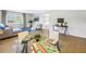 Open-concept living area with hardwood floors, a comfortable couch, and a view into the bedroom at 610 Cordova Ne Blvd, St Petersburg, FL 33704