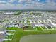An aerial view of the neighborhood showing backyard with fence in a lakefront community at 636 Olive Conch St, Ruskin, FL 33570