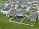 Aerial view of home with decorative backyard landscaping, white fence, and screened-in porch at 636 Olive Conch St, Ruskin, FL 33570