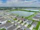 Aerial view showcasing a neighborhood home with well-kept yard and access to a scenic pond at 636 Olive Conch St, Ruskin, FL 33570