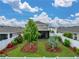 Well-manicured backyard featuring lush green lawn, a privacy fence, and beautiful landscaping at 636 Olive Conch St, Ruskin, FL 33570