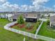 Aerial backyard view featuring decorative landscaping, a white fence, and covered patio at 636 Olive Conch St, Ruskin, FL 33570