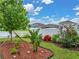 Landscaped flowerbed filled with decorative lights and various plants and flowers in a backyard at 636 Olive Conch St, Ruskin, FL 33570