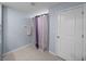 Bright bathroom featuring a modern shower curtain and a door to the hallway at 636 Olive Conch St, Ruskin, FL 33570