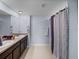 Bathroom with double sinks, modern fixtures, and a stylish shower curtain at 636 Olive Conch St, Ruskin, FL 33570