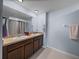 Bathroom featuring a double vanity with undermount sinks and modern fixtures at 636 Olive Conch St, Ruskin, FL 33570