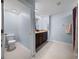 Bathroom with light blue walls, a toilet, and a dark brown vanity with double sinks at 636 Olive Conch St, Ruskin, FL 33570