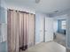 Bathroom featuring a modern shower curtain and a doorway leading to the Primary bedroom at 636 Olive Conch St, Ruskin, FL 33570