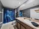 Modern bathroom featuring a double sink vanity, shower with curtain, and gray walls at 636 Olive Conch St, Ruskin, FL 33570