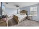 Light, airy main bedroom featuring hardwood floors, ceiling fan, and bright natural light at 636 Olive Conch St, Ruskin, FL 33570