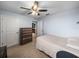 Bright bedroom with neutral carpet, chest of drawers, and white doors at 636 Olive Conch St, Ruskin, FL 33570