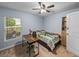 Comfortable bedroom featuring a desk, chair and cheerful bedding with bright natural light at 636 Olive Conch St, Ruskin, FL 33570