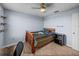Bedroom featuring a wooden bed frame, adjacent to a dark wood dresser and office space at 636 Olive Conch St, Ruskin, FL 33570