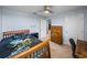 Bedroom featuring a wooden bed frame, adjacent to a dark wood dresser and office space at 636 Olive Conch St, Ruskin, FL 33570