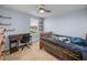 Bedroom with a desk, chair and window, complemented by shelving and a ceiling fan at 636 Olive Conch St, Ruskin, FL 33570