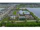 An aerial view of a community recreation center, showcasing a playground, pool, and lake views at 636 Olive Conch St, Ruskin, FL 33570