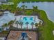 The community pool features palm trees and playground near a modern clubhouse at 636 Olive Conch St, Ruskin, FL 33570