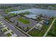 A neighborhood pool is shown with palm trees and has a clubhouse, playground, and parking lot at 636 Olive Conch St, Ruskin, FL 33570