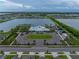 Aerial photo of community center featuring a pool, playground, and lake views, with landscaping at 636 Olive Conch St, Ruskin, FL 33570