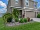 Charming landscaping highlights the front of this home featuring a two-car garage at 636 Olive Conch St, Ruskin, FL 33570