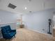 Comfortable hallway featuring carpeted floors, bright natural light and a blue accent chair at 636 Olive Conch St, Ruskin, FL 33570