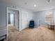 Comfortable hallway featuring carpeted floors, bright natural light and a blue accent chair at 636 Olive Conch St, Ruskin, FL 33570