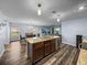 Spacious kitchen with a center island that seamlessly connects to the living and dining spaces at 636 Olive Conch St, Ruskin, FL 33570