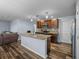 Stylish kitchen featuring granite counters, stainless steel appliances, and an island overlooking the living area at 636 Olive Conch St, Ruskin, FL 33570