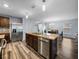 Bright kitchen with stainless steel appliances, center island and an open view into the dining and living areas at 636 Olive Conch St, Ruskin, FL 33570