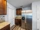 Kitchen with granite countertops, a stainless steel refrigerator, and dark wood cabinets at 636 Olive Conch St, Ruskin, FL 33570
