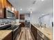 Kitchen with stainless steel appliances, granite counters, tile backsplash, and wood-look flooring at 636 Olive Conch St, Ruskin, FL 33570