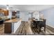 Open-concept kitchen boasts granite counters, stainless appliances, and wood-look floors adjoining the dining area at 636 Olive Conch St, Ruskin, FL 33570
