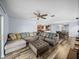 Bright, open living room with hardwood floors, modern ceiling fan and lots of natural light at 636 Olive Conch St, Ruskin, FL 33570