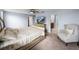Spacious main bedroom with a ceiling fan, TV, and an adjacent bathroom and walk-in closet at 636 Olive Conch St, Ruskin, FL 33570