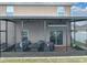 Screened patio featuring comfortable seating and ceiling fans at 636 Olive Conch St, Ruskin, FL 33570