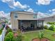 Enjoy the outdoors on this screened-in patio with garden views in this meticulously maintained lawn at 636 Olive Conch St, Ruskin, FL 33570
