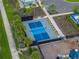 Aerial view of community pickleball court and playground in a fenced area with seating at 636 Olive Conch St, Ruskin, FL 33570