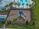 Aerial view of community playground showcasing modern play structures, palm trees, and proximity to a pool at 636 Olive Conch St, Ruskin, FL 33570