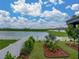 Beautiful view of the pond from backyard featuring well maintained lawn and decorative landscaping at 636 Olive Conch St, Ruskin, FL 33570