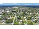 Expansive aerial view of neighborhood showcasing lush greenery and residential streets under a bright blue sky at 6704 70Th N Ave, Pinellas Park, FL 33781