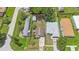 Aerial view of a property with a spacious backyard, storage shed and green surroundings at 6704 70Th N Ave, Pinellas Park, FL 33781