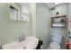 Bathroom featuring white vanity, toilet, and wood shelves at 6704 70Th N Ave, Pinellas Park, FL 33781