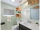 Bathroom with dark vanity, white sink and toilet, and rustic shelves at 6704 70Th N Ave, Pinellas Park, FL 33781