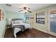 Charming bedroom features a ceiling fan, dark wood floors, and neutral paint at 6704 70Th N Ave, Pinellas Park, FL 33781