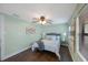 Cozy bedroom boasts a ceiling fan, warm paint color, and wood-look floors at 6704 70Th N Ave, Pinellas Park, FL 33781
