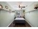 Charming bedroom with white floating shelves, and wood-look floors at 6704 70Th N Ave, Pinellas Park, FL 33781
