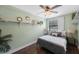 Bedroom featuring a ceiling fan, decorative shelves, and wood-look floors at 6704 70Th N Ave, Pinellas Park, FL 33781